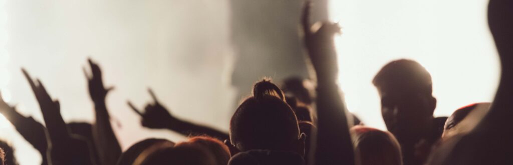 dancing at a concert while the singer is performing surrounded by lights